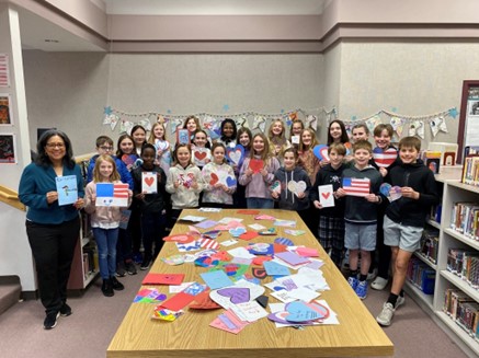 Congresswoman with students making Valentines for Veterans