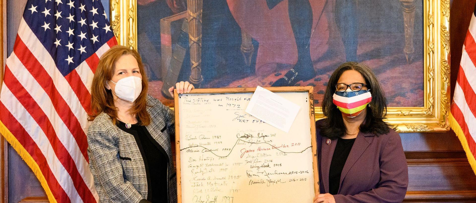 Strickland and Schrier Hold the Back of "Chick Photo" as Part of WA Delegation Tradition